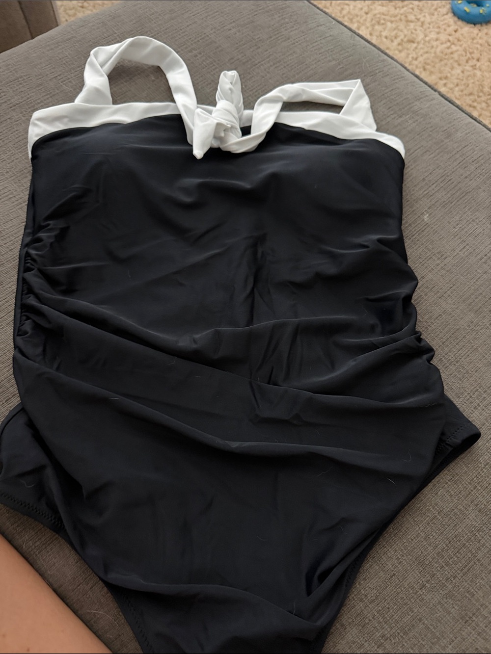 Chic Black halter one piece bathing suit with white Accent and neck knot tied